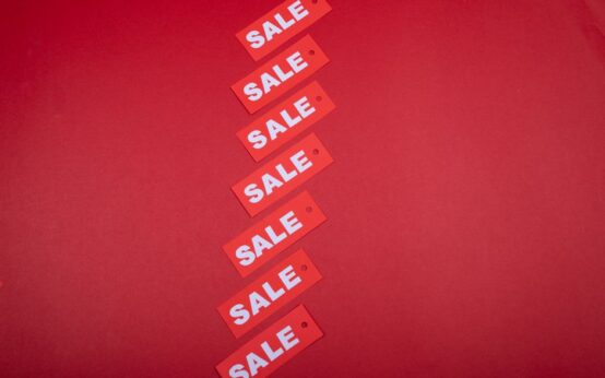 Diagonal row of red sale tags on a red background. Ideal for advertising promotions.